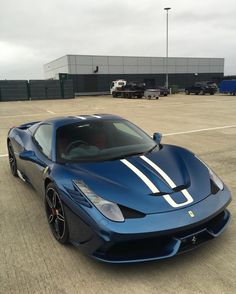 a blue sports car parked in an empty parking lot