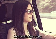 a woman sitting in the back seat of a car