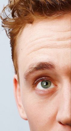 a close up of a person with green eyes