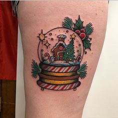 a snow globe with a christmas tree inside and candy canes on the bottom of it