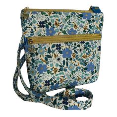 Gorgeous blue and gold crossbody bag for everyday use! Stunning detail in the fabrics accented with darling flower zipper pulls. Exterior features a zipper pocket perfect for your phone, keys, lip balm, etc. Interior is lined in a blue and gold coordinating fabric. Strap is adjustable to meet your desired size. *ear buds and lip balm not included* Blue Bags With Zipper Pocket For Personal Use, Blue Shoulder Bag With Zipper Closure As Gift, Blue Shoulder Bag With Zipper Closure, Ideal As Gift, Crossbody Bag Diy, Gold Crossbody Bag, Ear Buds, Bag Diy, Coordinating Fabrics, Zipper Pulls