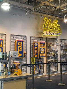 the inside of a store with yellow and blue banners on the wall, along with other items