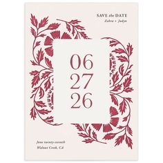 save the date card with red leaves and numbers on white paper, in an ornate frame