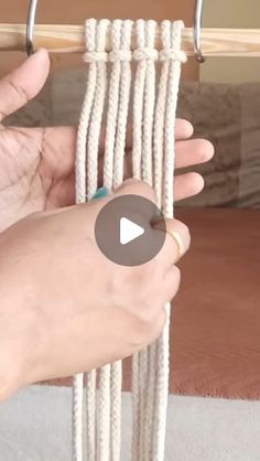 a person is holding up a white rope