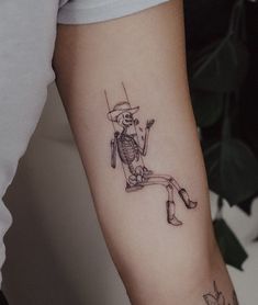 a person with a skeleton tattoo on their arm