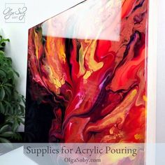 an abstract painting on the wall next to a potted plant