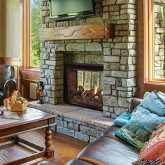 a living room filled with furniture and a flat screen tv mounted above a fire place