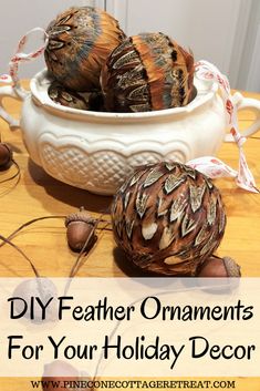 some ornaments are sitting in a bowl on a table with the words diy feather ornaments for your holiday decor