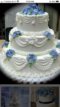 three tiered wedding cake with blue flowers on top and white frosting in the middle