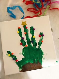 a handprinted cactus on a piece of paper with colored streamers around it