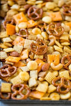 a tray full of cheetos and pretzels with pretzels in the middle