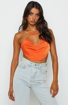 * Orange Crop Top 
 * Orange is the colour of the Summer season! We're totally obsessing over this crop top, () style with a midi skirt () and heels for the perfect, stylish look!  
 * Cross front cami 
 * Scoop hem 
 * Cowl neckline 
 * Lined 
 * Mid-weight silk-like material with slight stretch 
 * Open back with tie up back strap 
 * Cropped length Crop Top Style, Orange Crop Top, Prom Midi Dress, Beginning Boutique, Strapless Tops, Cowl Neckline, Long Crop Top, Crop Top Sweater, One Shoulder Tops