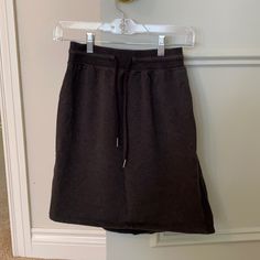 Lulu On The Fly Skirt In The Most Cozy Sweatpant Material! Dark Grey. Never Worn Relaxed Solid Skirt For Loungewear, Casual Workout Skirt With Elastic Waistband, Lululemon Skirt, The Fly, Dark Grey, Lululemon Athletica, Womens Skirt, Sweatpants, Size 4