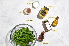 green beans and other ingredients on a white counter top with labels for different types of sauces