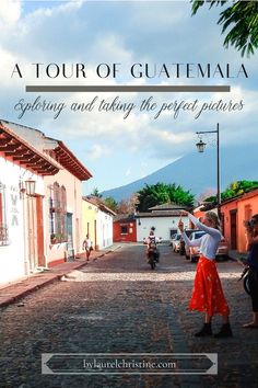 a woman in a red skirt standing on a cobblestone street with the words a tour of guatemala