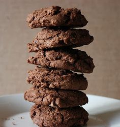 a stack of chocolate cookies sitting on top of a white plate