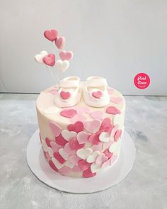 a pink and white cake with hearts on it