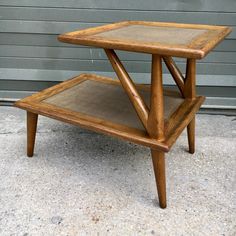 a wooden table sitting on top of a sidewalk