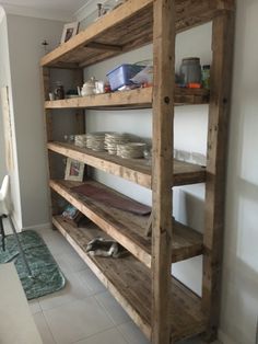 the shelves are made out of wood and have plates on them