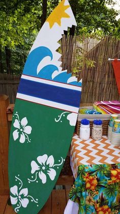 two surfboards sitting on top of a wooden table