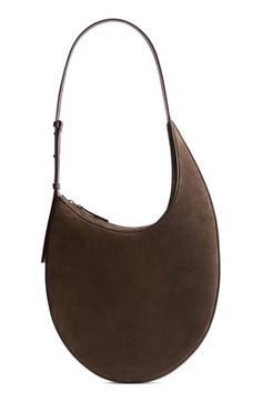 Minimalist styling lets the impeccable leather craftsmanship shine on this slim hobo made of velvety suede set off with smooth leather. Top zip closure Adjustable shoulder strap Leather Made in Italy Designer Handbags Modern Leather Hobo Bag With Suede Lining, Elegant Leather Hobo Bag With Suede Lining, Modern Shoulder Bag With Suede Lining, Modern Suede Shoulder Bag With Textured Leather, Elegant Suede Shoulder Bag With Zipper, Elegant Suede Shoulder Bag With Zipper Closure, Modern Suede Bag With Zipper Closure, Modern Textured Suede Shoulder Bag, Luxury Suede Shoulder Bag With Zipper Closure