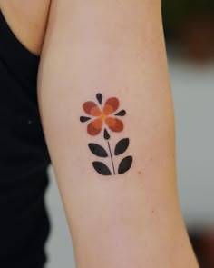 a woman with a flower tattoo on her arm