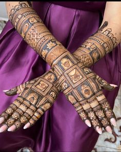 two hands with henna designs on them