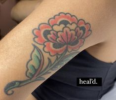 a woman's arm with a flower tattoo on the left side of her body