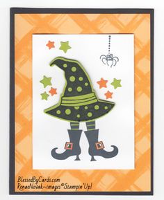 an orange and black card with a witch's hat