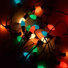 multicolored christmas lights are lit up in the dark