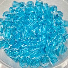 blue glass beads in a bowl on a table