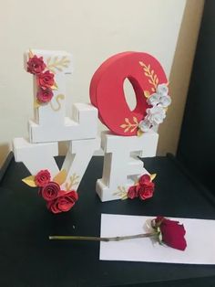 the letters are decorated with flowers and ribbons