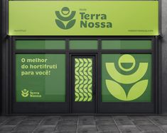 there is a green sign on the side of this store front window that says terra nossa