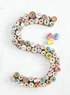 the letter s made out of spools of thread