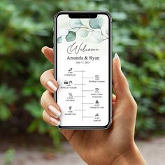 a person holding up an iphone with the wedding date on it in front of some bushes