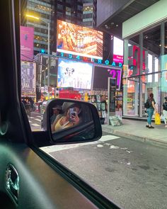 a car's rear view mirror is shown in the city