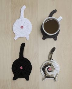 four crocheted coasters with cats on them and a cup of coffee in the middle