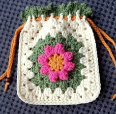 a crocheted bag with a flower on it