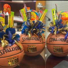 two basketballs decorated with blue and gold ribbons