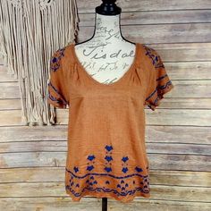 Scoop Neck, Keyhole Back. All-Over Embroidered Design. Color: Burnt Orange/Navy Measurements: Bust 36” Length 23” Please Note That This Fabric Looks Like It Has Piling But This Is By Design Of The Fabric. O30 Orange Short Sleeve Tops With Floral Embroidery, Orange Embroidered Tops For Summer, Orange Embroidered Top For Beach, Orange Cotton Top With Floral Embroidery, Fitted Embroidered Orange Tops, Orange Floral Embroidery Short Sleeve Tops, Orange Embroidered Beach Top, Orange Floral Embroidered Short Sleeve Tops, Orange Embroidered V-neck Top