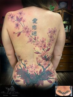 the back of a woman's body with flowers on it