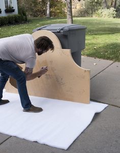 a man is placing something on top of a white sheet