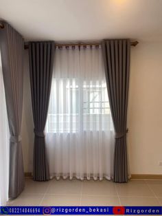 an empty room with curtains and tile flooring