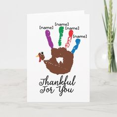 a thanksgiving card with a handprinted turkey and the words thank you on it