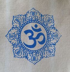 an omen symbol is shown on the side of a piece of cloth with blue and white designs