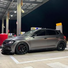 a silver car parked in front of a gas station