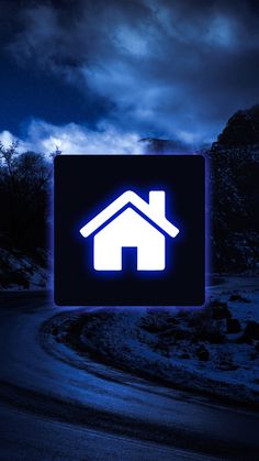 a blue house sign sitting on the side of a road in front of a dark sky