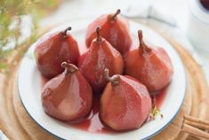 some pears are sitting on a white plate