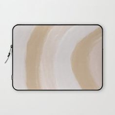 a laptop sleeve with an abstract design on the front and side, in neutral tones