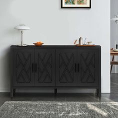 a room with a black cabinet and rug